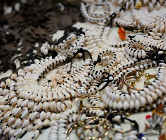 Colliers en coquillages blancs artisanaux exposés à World in Paris